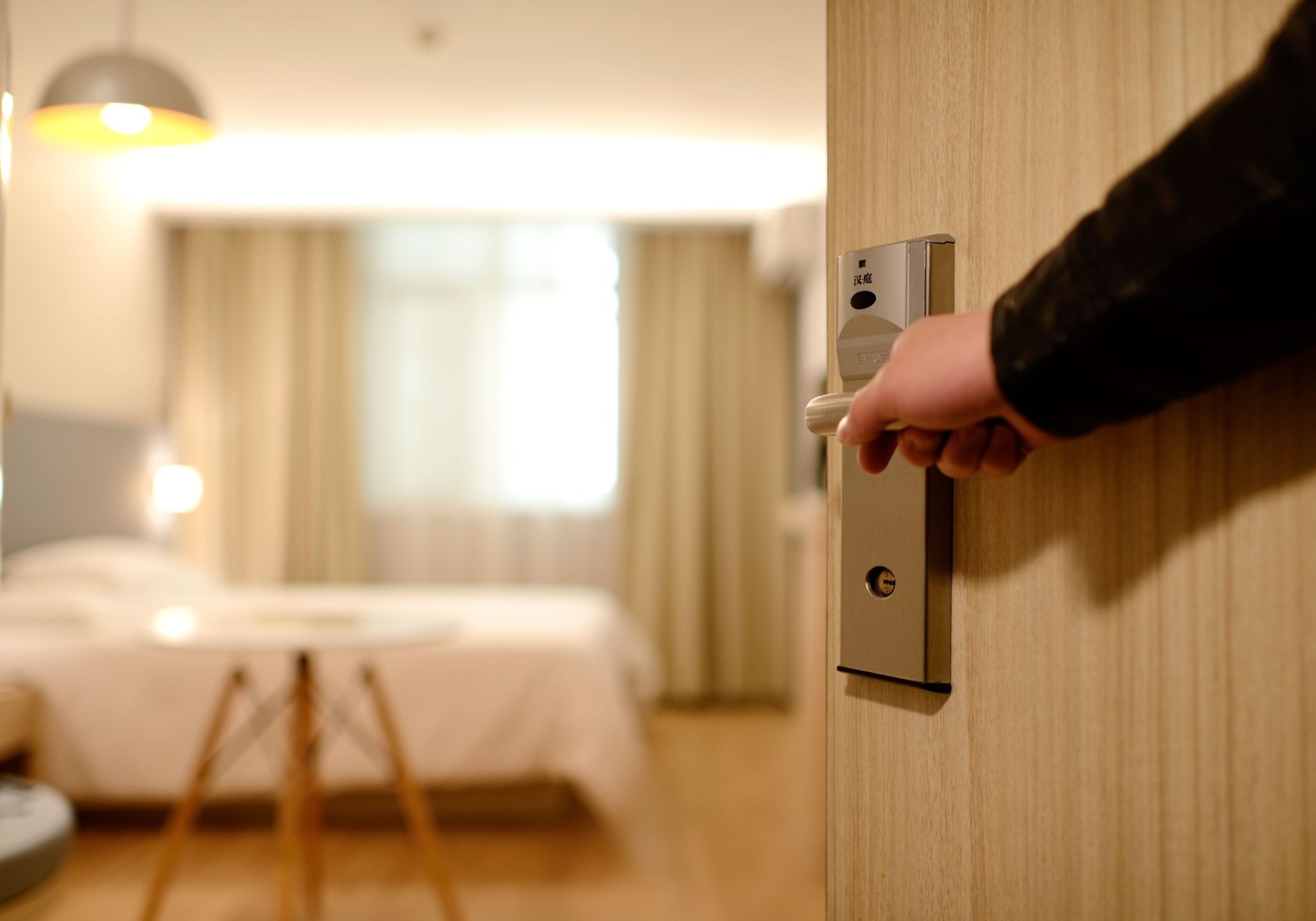 Person closing door to hotel room