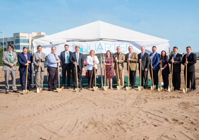 Group of people with golden shovels at groundbreaking event